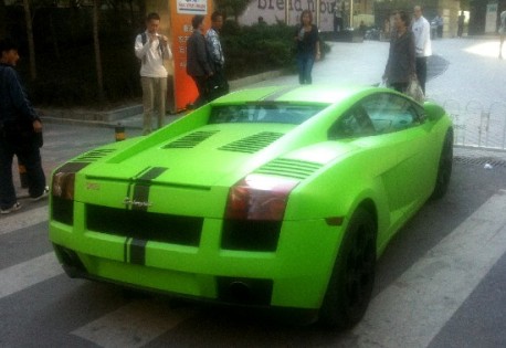 Painted in limegreen with black racing stripes and blacked out wheels