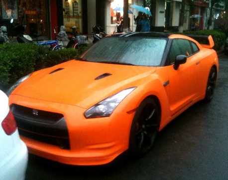 Here we have a very orange Nissan GT R, seen in my own street in Beijing on . Used it is a quality bargain.