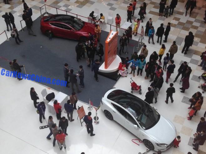 Five-year old Kid starts Tesla Model S in a shopping mall in China, hits a baby